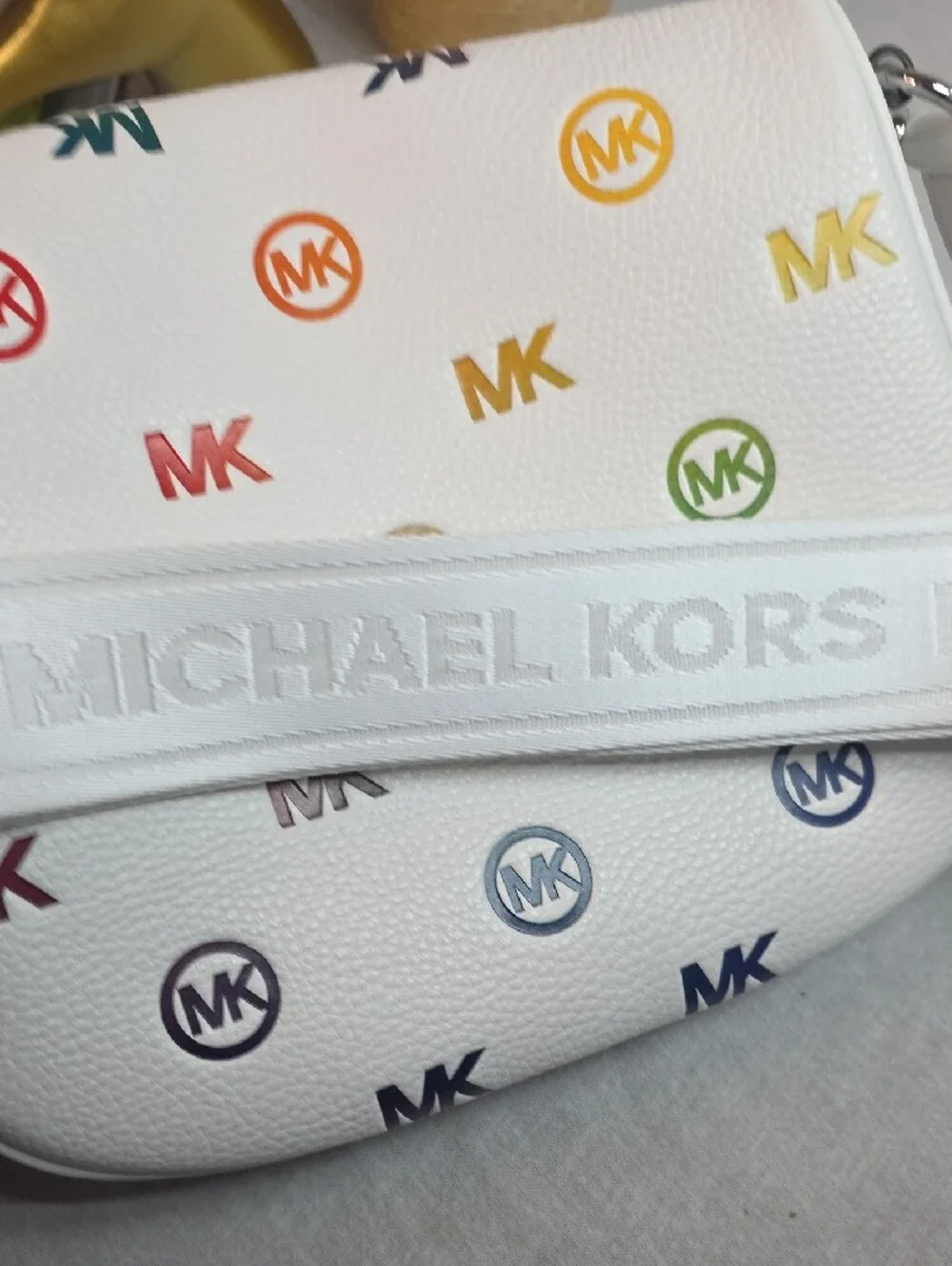Michael Kors Slater Medium Rainbow Logo Embossed Sling Pack in Optic White